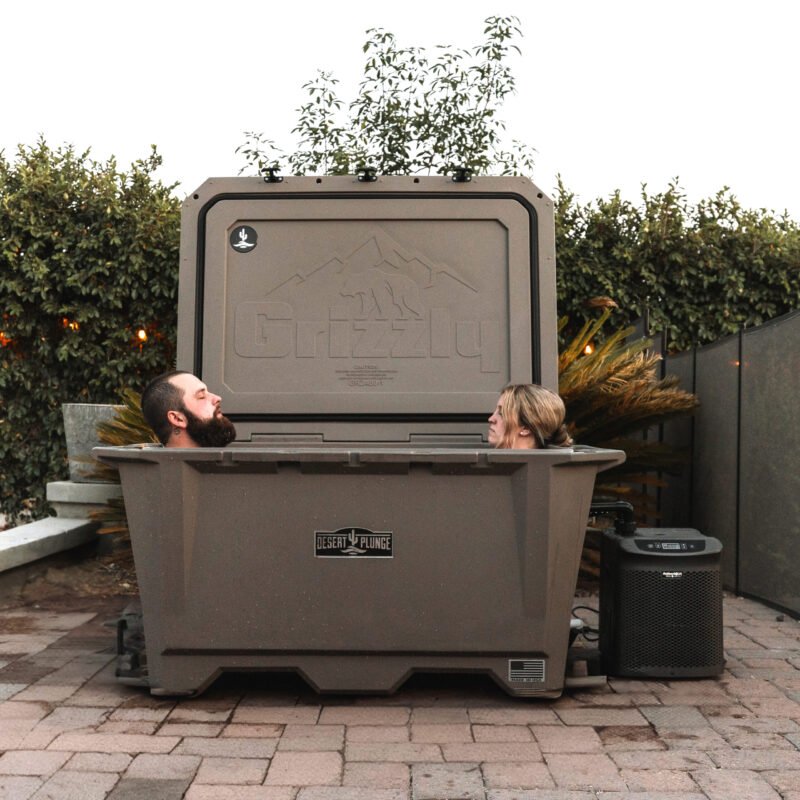 A photo of a man and a woman cold plunging together in a Desert Plunge 450 Wide cold plunge.